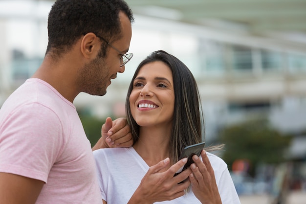 Smiling young couple looking at each other