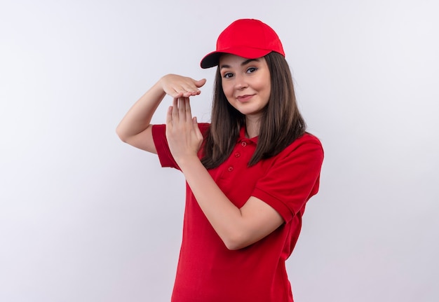 Free photo smiling young delivery woman wearing red t-shirt in red cap showing timeout on isolated white wall