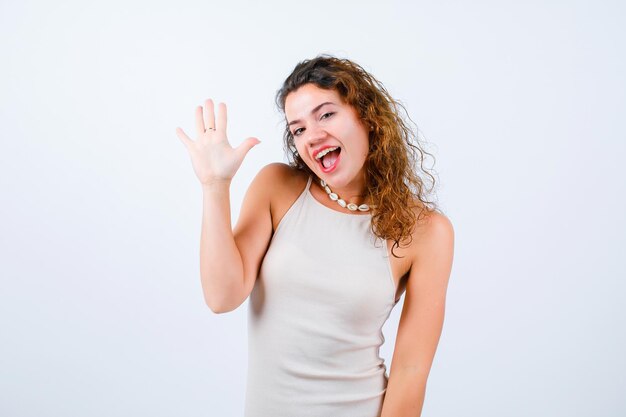 Smiling young girl is raising up her handful on white background