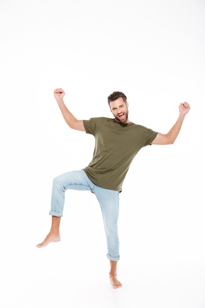 Smiling young man standing isolated.