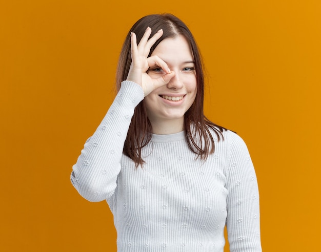 Free Photo smiling young pretty girl doing look gesture 