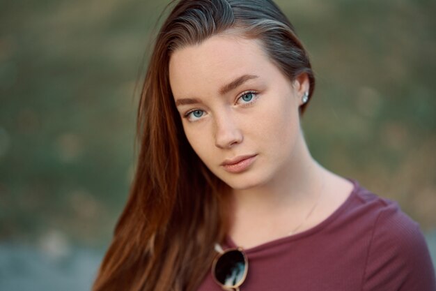 Smiling young woman closeup portrait outdoors