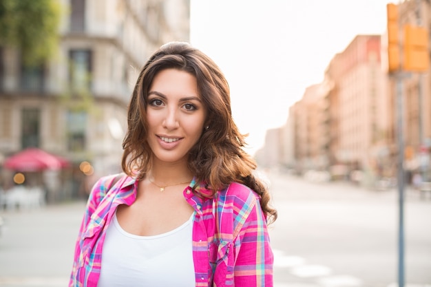 Smiling young woman having summer stroll