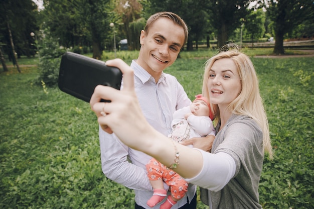 Smiling young woman taking a photo with her family