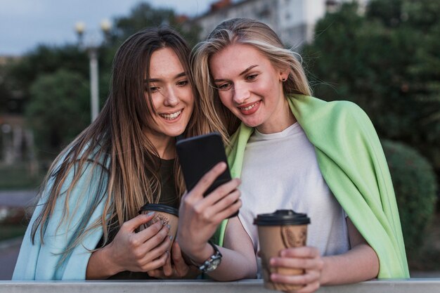 Smiling young woman taking a picture