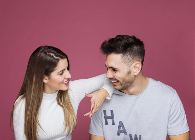 Smiling young woman with hand on man shoulder