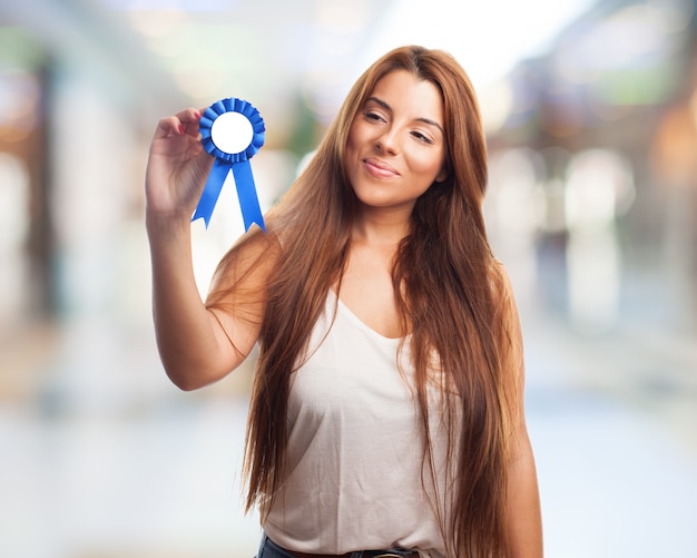 Free Photo smiling young woman with a medal