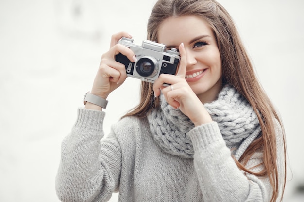 smiling young woman with photo camera outdoor