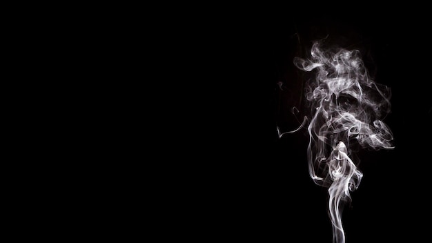 Smoke shapes movement over black background with copy space for writing the text