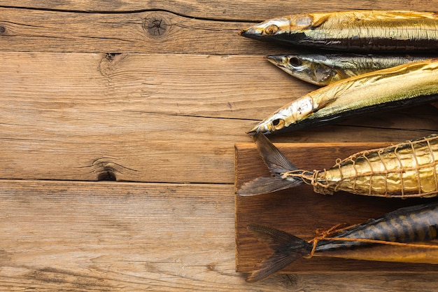 Smoked fishes on wooden table