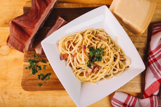 Smoked meat and cheese near pasta