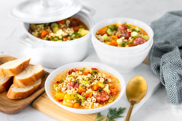 Free photo smoked sausage minestrone italian soup with pasta and seasonal vegetables