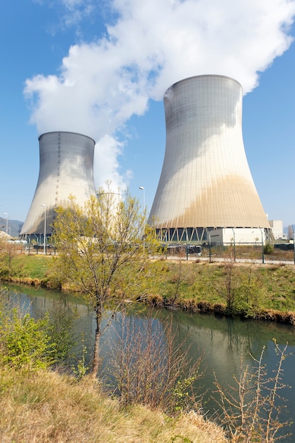 Free Photo smokestacks of nuclear factory and river in summer