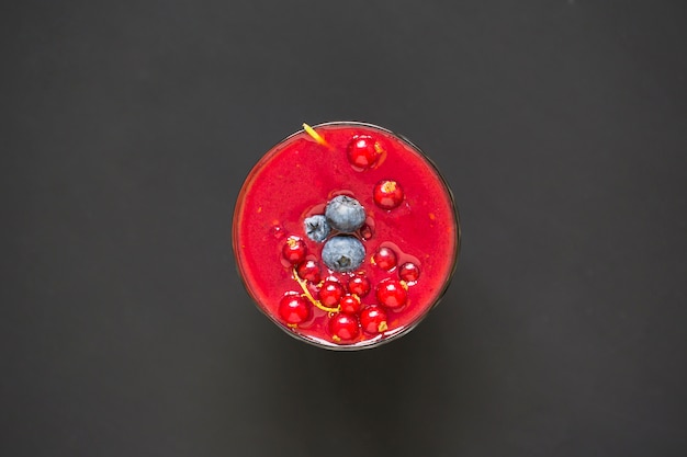 Free Photo smoothie with berries in a glass on black background