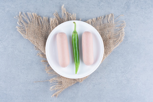 Free Photo snack for breakfast. boiled sausage with pepper