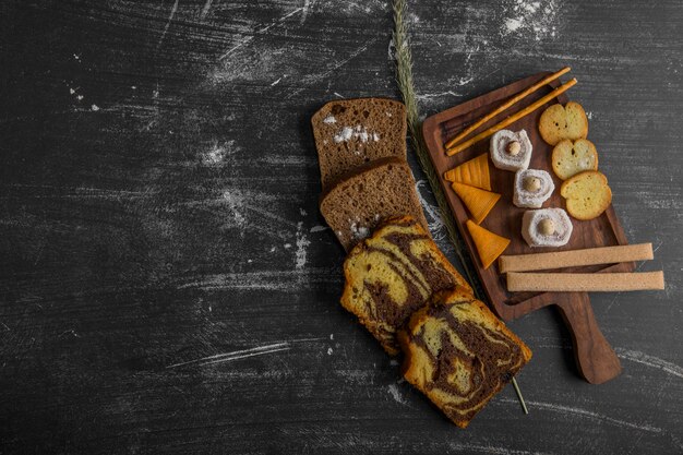 Snack and pastry board with sliced cake