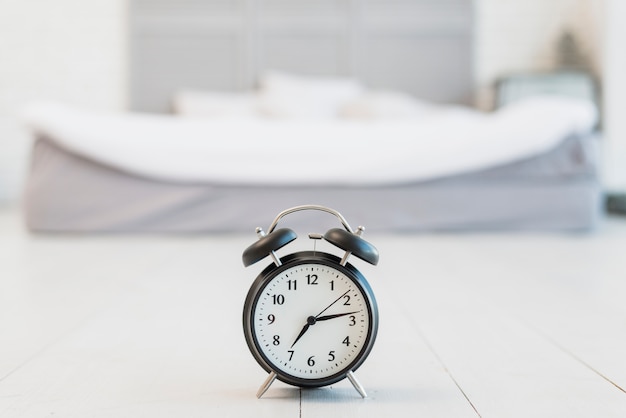 Snooze on floor near bed with white linen