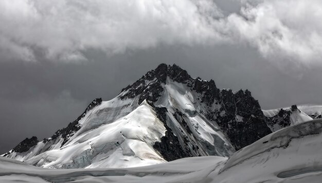 Snow covered mountain under cloudy sky during daytime