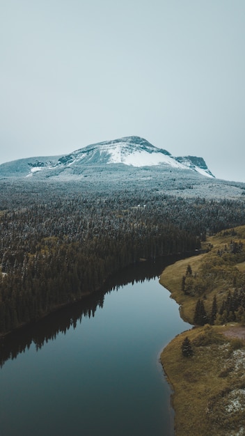 Snow covered mountain behind a river