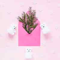 Free photo snowflakes and bears around envelope with conifer twigs