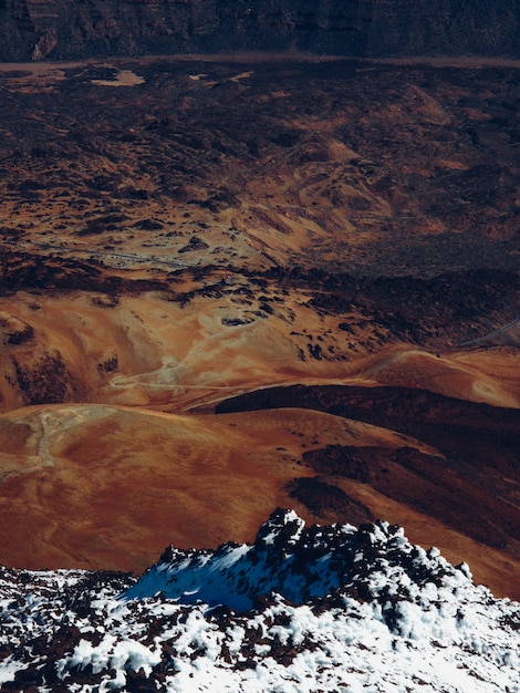 Free Photo snowy mountain near dry hills