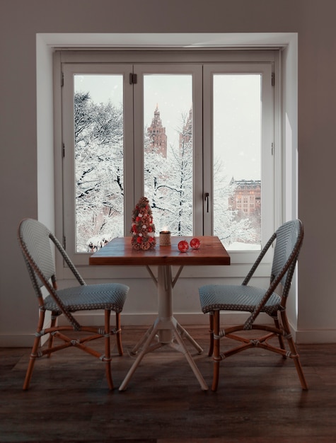 Free photo snowy window with christmas interior decor