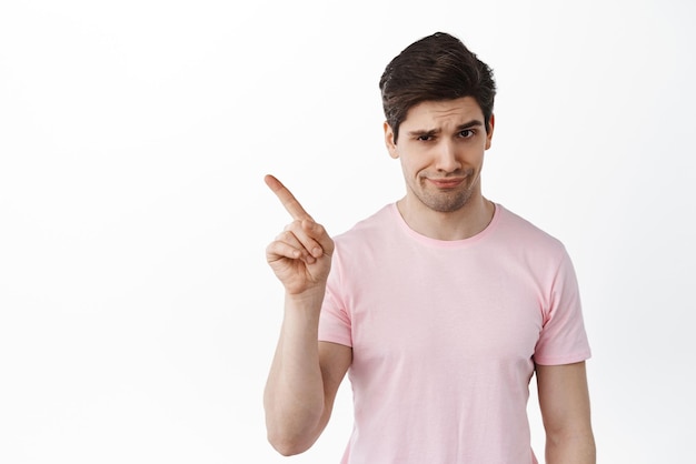 Not so fast Man shaking finger in rejection prohibit or forbid something scolding for bad behavior smirk and frown disappointed standing over white background