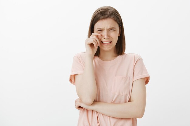 Sobbing and crying woman wiping tears having mental breakdown, feeling sad