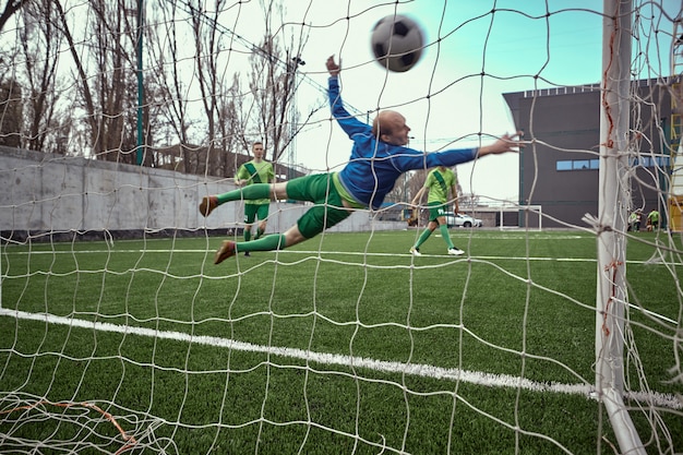 Free photo soccer football goalkeeper making diving save