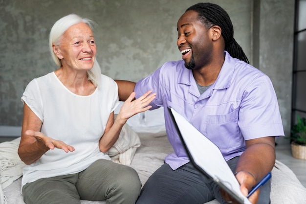 Social worker taking care of an old woman