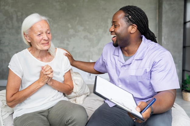 Social worker taking care of an old woman