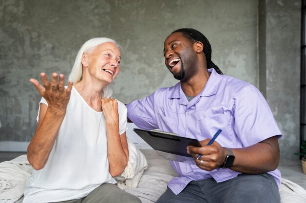 Social worker taking care of an old woman