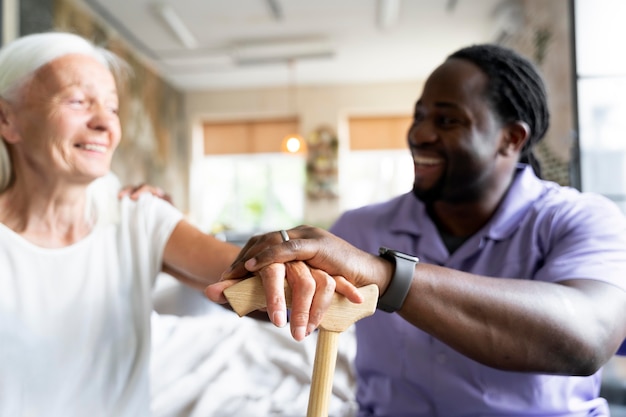 Social worker taking care of an old woman