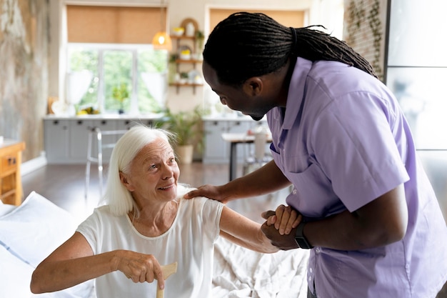 Social worker taking care of an old woman