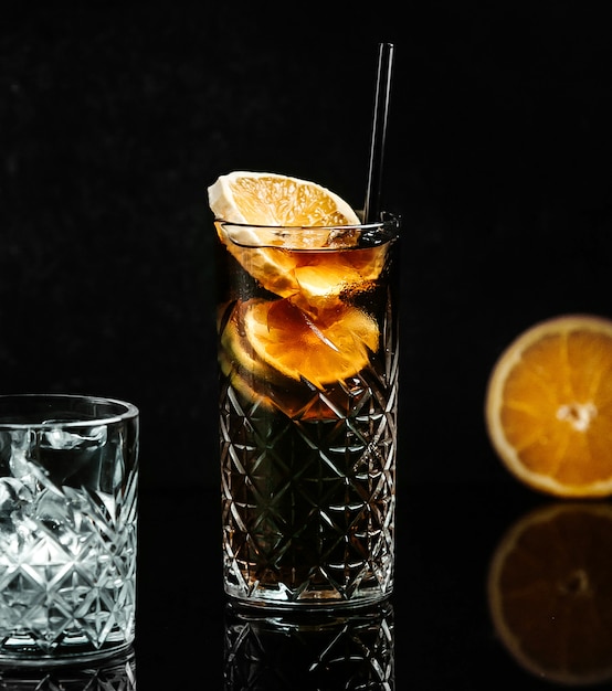 Soda in black glass with lemon slice