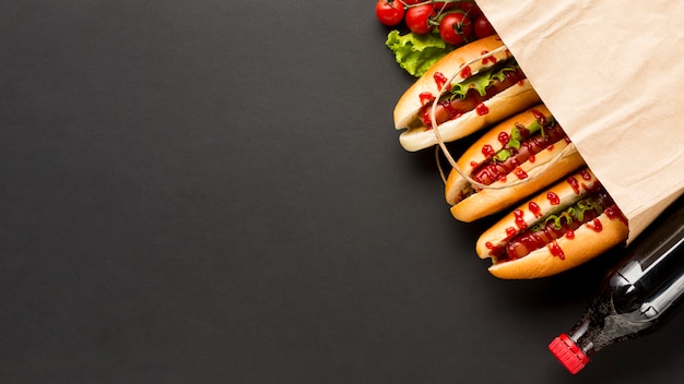 Soda and hot dogs in plastic bag