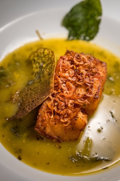 Free Photo soft focus of a cod fish dish with a relish of spinach in a white bowl