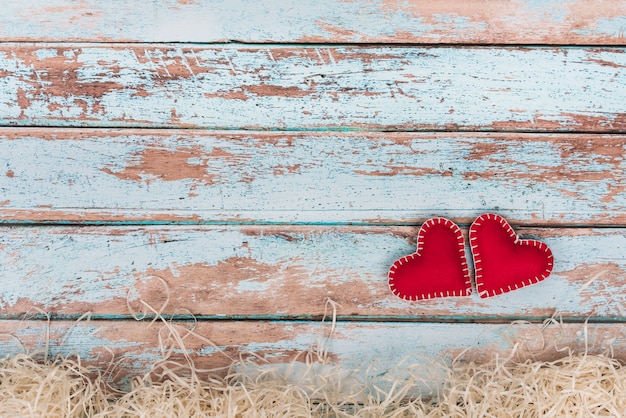 Free Photo soft toy hearts on blue wooden table