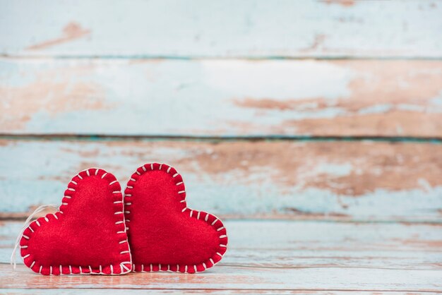 Soft toy hearts on wooden table