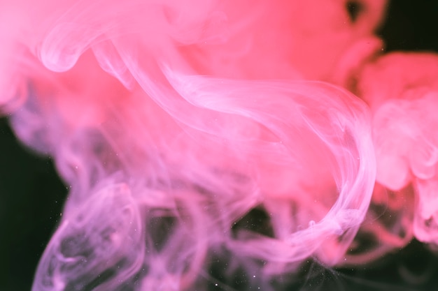 Free photo soften pink smoke on black background