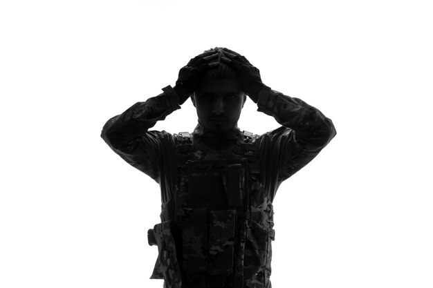 Soldier silhouette serious handsome strong tough army soldier in uniform holding head