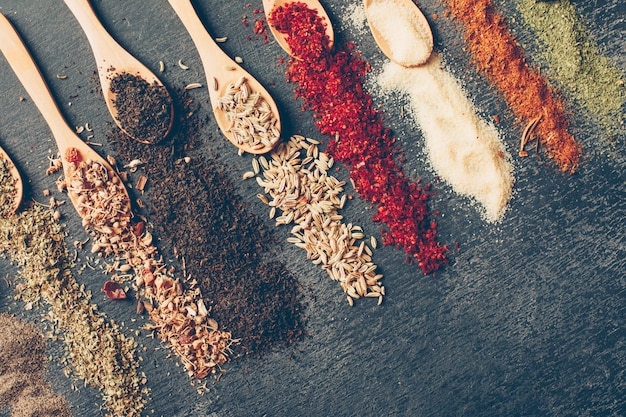 Free photo some dried herbs in spoons, flat lay.