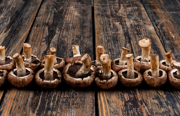 Free photo some flipped mushrooms on dark wooden table