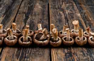 Free photo some flipped mushrooms on dark wooden table