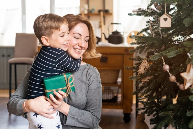 Son hugging mother after receiving present