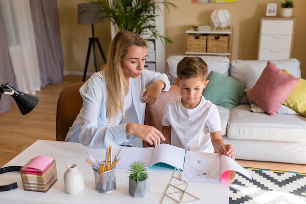 Son showing her mother a drawing