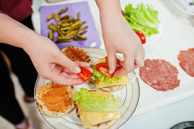 Sooking burgers in the kitchen at home during quarantine time