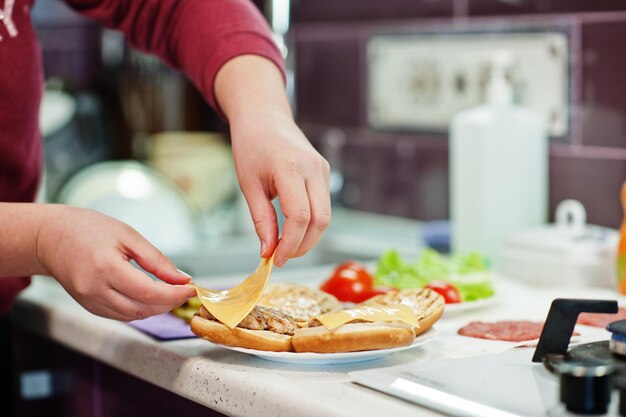 Sooking burgers in the kitchen at home during quarantine time