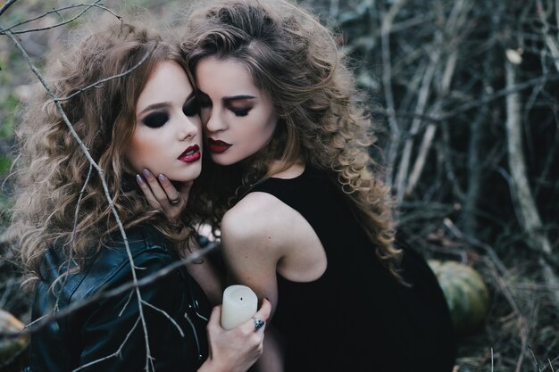 Sorceresses holding a white candle