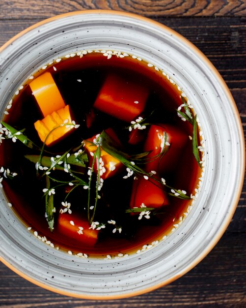 Soup served with greens and seeds